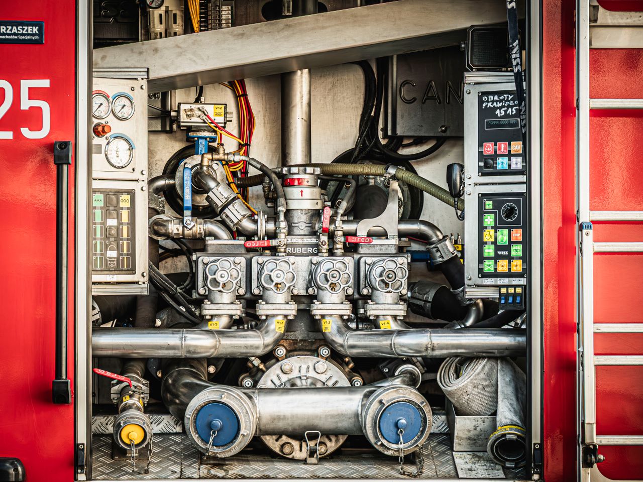 Home Detailed view of fire truck equipment showcasing gauges, valves, and hoses in Wrocław, Poland.